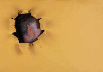 ear in a yellow paper hole