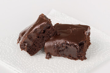 Delicious chocolate brownies on a white napkin