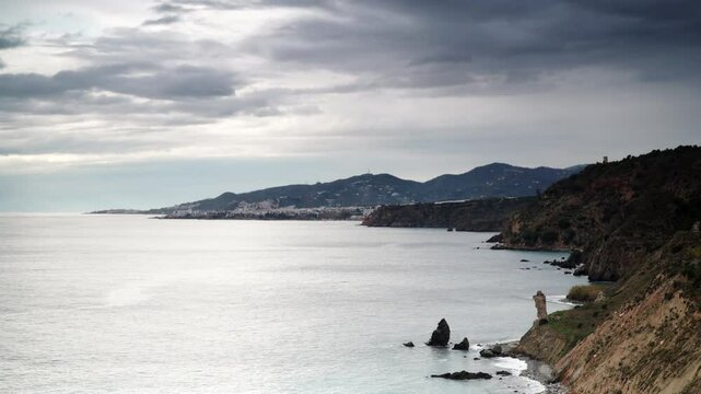Time lapse of dark clouds moving over spanish coast in Andalucia. Cliffs of Maro Cerro Gordo Natural Park, near Maro and Nerja, Malaga province, Costa Del Sol, Spain.
