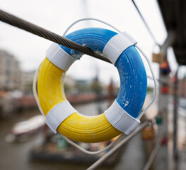 Small lifebuoy (key fob) in the colors of Ukraine in the port of Hamburg.