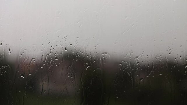 Thunderstorm outside the window, raindrops and lightning. Gloomy weather outside, summer rain