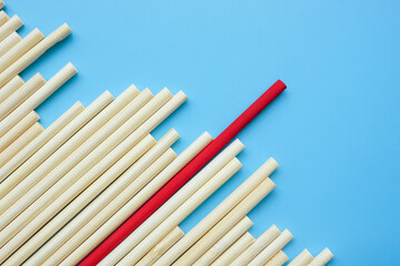 Wooden sticks and red one. Leadership or Uniqueness abstract art.