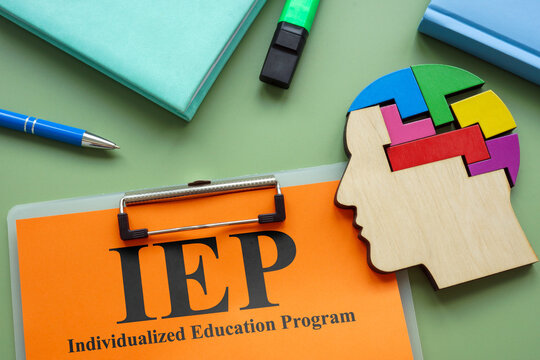 Clipboard with IEP Individualized Education Program and head model.