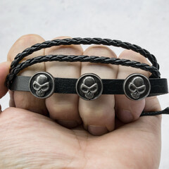 Black leather bracelet with skulls, Jolly Roger, Pirate style. An accessory for rockers, bikers,...