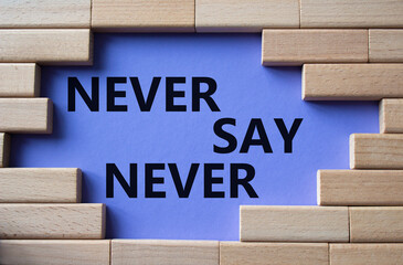 Never say Never symbol. Concept words Never say Never on wooden blocks. Beautiful purple background. Business and Never say Never concept. Copy space