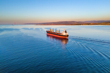 Dry bulk cargo ship underway in sea. Bulk carrier or bulker is a merchant ship to transport unpackaged bulk cargo