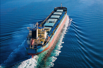 Bulk cargo carrier ship underway in calm sea. Dry cargo vessel merchant ship to transport bulk...