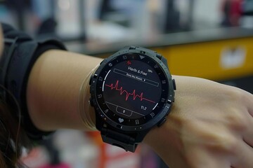 Fototapeta premium close-up shot of a person's hand wearing a smartwatch that shows their heartbeat rate on the digital screen.