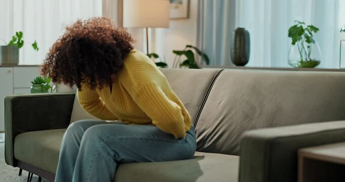 Woman, stomach and pain with discomfort or cramps in food poisoning, indigestion and bloating in home. Female person, tummy ache and gut health with abdominal muscle strain, menstrual cycle or nausea
