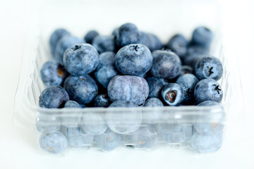 Plastic Container Filled With Blueberries on Table
