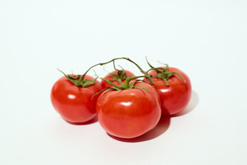 Four Tomatoes on White Table