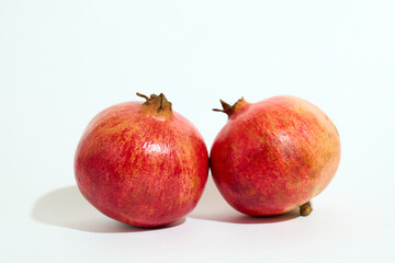 Two Pomegranates on White Surface