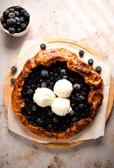 Homemade crispy blueberry galette, on a wooden board