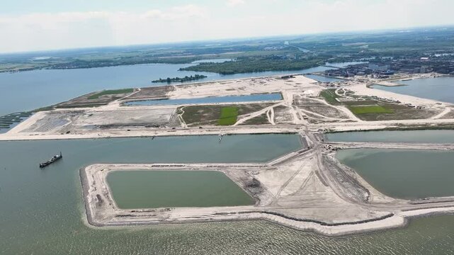 The artificially created StrandEiland under construction, nearby IJburg Amsterdam, the Netherlands from the air by helicopter