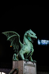 Dragon bridge and the Dragon statue with the Ljubljana castle at night
