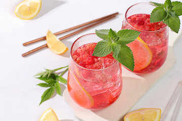 Refreshing summer homemade lemonade cocktail, mojito with raspberries, currants, mint and lemon, weight loss concept, Detox water with fruit flavor on a light background. healthy and natural food,