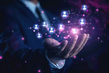 digital hologram of business network with people icons connected by lines on hand in dark blue suit holding it close to camera, background is blurred and black Generative AI