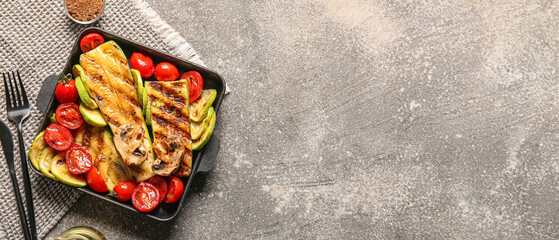Baking dish with tasty grilled vegetables on grunge background