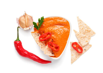 Bowl of tasty muhammara and ingredients on white background