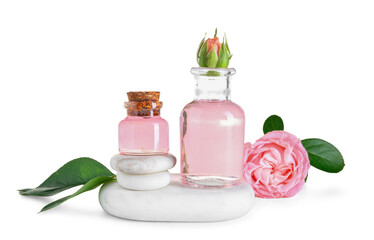 Bottles of cosmetic oil with rose extract and flowers on white background