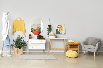 Stylish interior of light room with clean clothes