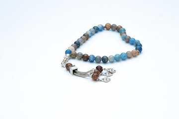 Rosary or prayer beads, isolated on white background	
