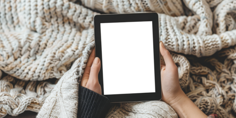 Person holding a tablet with a transparent screen in a cozy, festive home setting. Concept of technology and holiday relaxation. Perfect for tech, lifestyle, and holiday promotions.