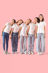 Obraz premium Beautiful women with pink ribbons holding hands on color background. Breast cancer awareness concept