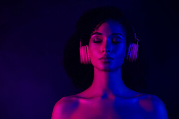 Photo of dreamy seductive lady wear bra earphones listening songs empty space isolated dark blue color background