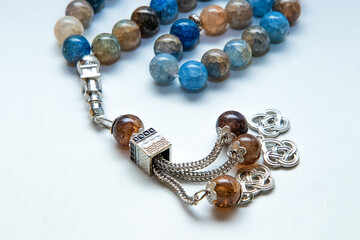 Close up- rosary or prayer beads, isolated on white background	
