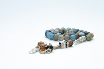 Rosary or prayer beads, isolated on white background	
