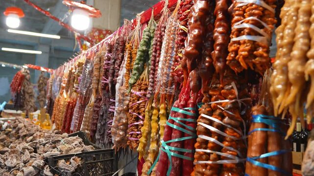 Georgian dessert - Churchkhela, popular snack made from nuts and friut juice. Churchkhela hanging in local store. Traditional food. Churchkhela Klosap at street market.