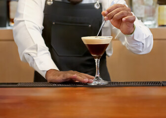Unrecognizable Bartender Making an Espresso Martini Cocktail