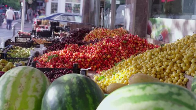 a grocery store or market filled with variety of fruits and vegetables, with blurred background, buyers and sellers in city center. Street fruit shop with fresh fruits and vegetables