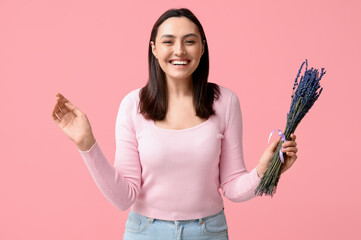 Beautiful happy young woman with bouquet of lavender flowers on pink background