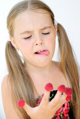 a mischievous, cheerful little girl with freckles rejoices and makes faces