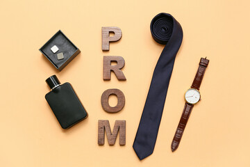 Word PROM with tie, cufflinks and wristwatch on beige background