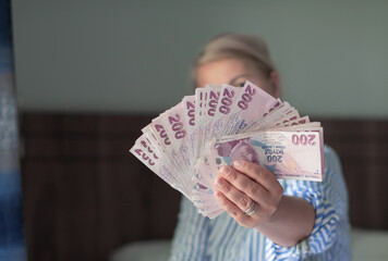 a large fan of 200 Turkish lira in the hands of a tourist in Turkey, a lot of money for shopping,...