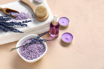 Beautiful composition with candles, bottle of lavender oil and sea salt on beige background, closeup