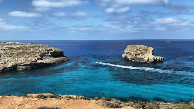 Comino Island Malta, Water scooters in between to rocks. Visiting caves in Comino . High quality 4k footage