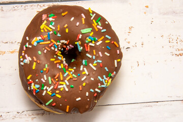 Delicious dessert. chocolate donuts with multicolored sprinkles.