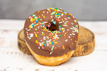 Delicious dessert. chocolate donuts with multicolored sprinkles.