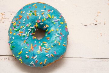 Delicious dessert. blue donuts with multicolored sprinkles.