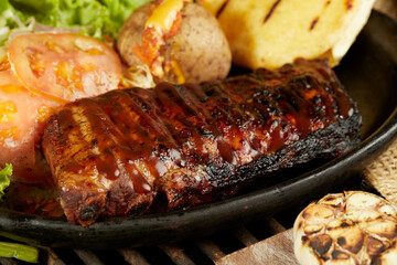 grilled ribs covered in bbq sauce