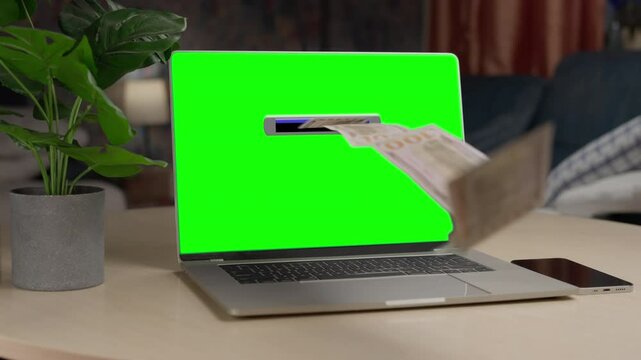 Money rain flying out of the laptop like ATM banking machine. Green screen. Make money online. Cash flow, dollar bills floating out of the laptop screen. Business making easy money online concept. 