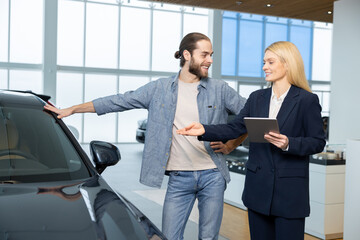 Male customer in a showroom talking to a female sale assistant