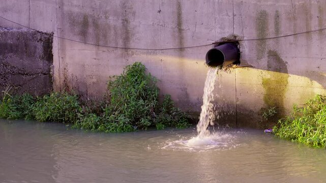 Draining sewage from pipe into river Concept of pollution rivers and ecology Water pollution sewer drain pipe dirt sewage water drain Bad waste water from city wastewater management