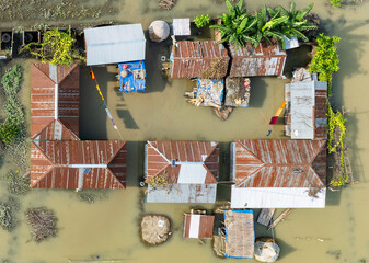 Aerial view showcasing the devastating impact of floods on villages in Northern Bangladesh,...