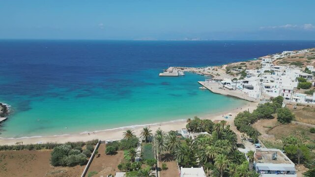A stunning aerial view of Donousa Island in the Cyclades, Greece, featuring a picturesque white sand beach and crystal clear turquoise waters.