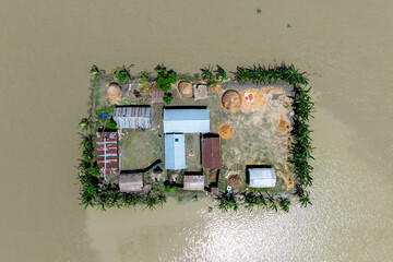 Aerial view showcasing the devastating impact of floods on villages in Northern Bangladesh,...